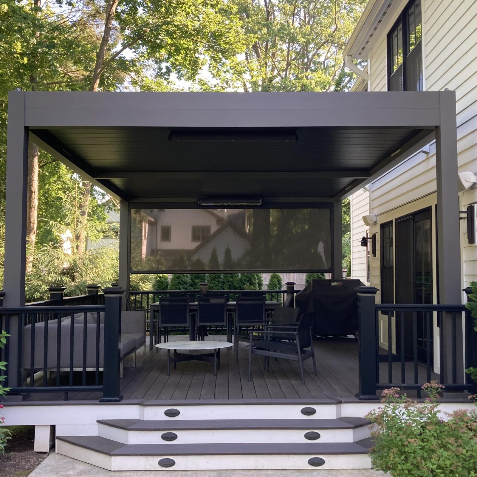 Motorized louvered pergola with smart controlled adjustable louvers and MagnaTrack motorized screens. Available from the best Pergola Installer in Bellevue.