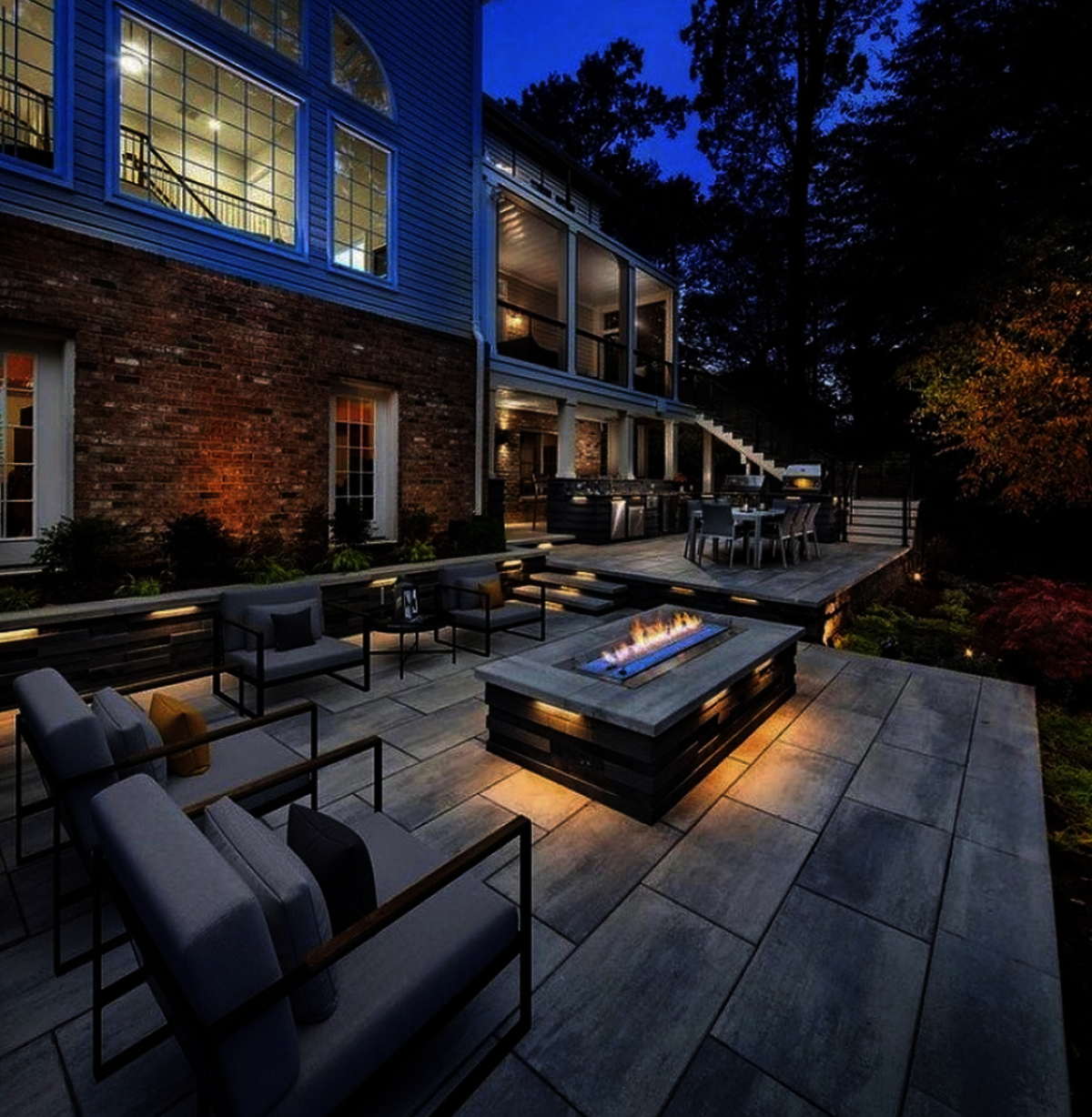 Outdoor living project showcasing stunning paver patio installation with modern fire pit, outdoor kitchen, retaining wall and landscape lighting | Expert Ward-Winning Landscape Design/Build in Bellevue | Home Service Specialists