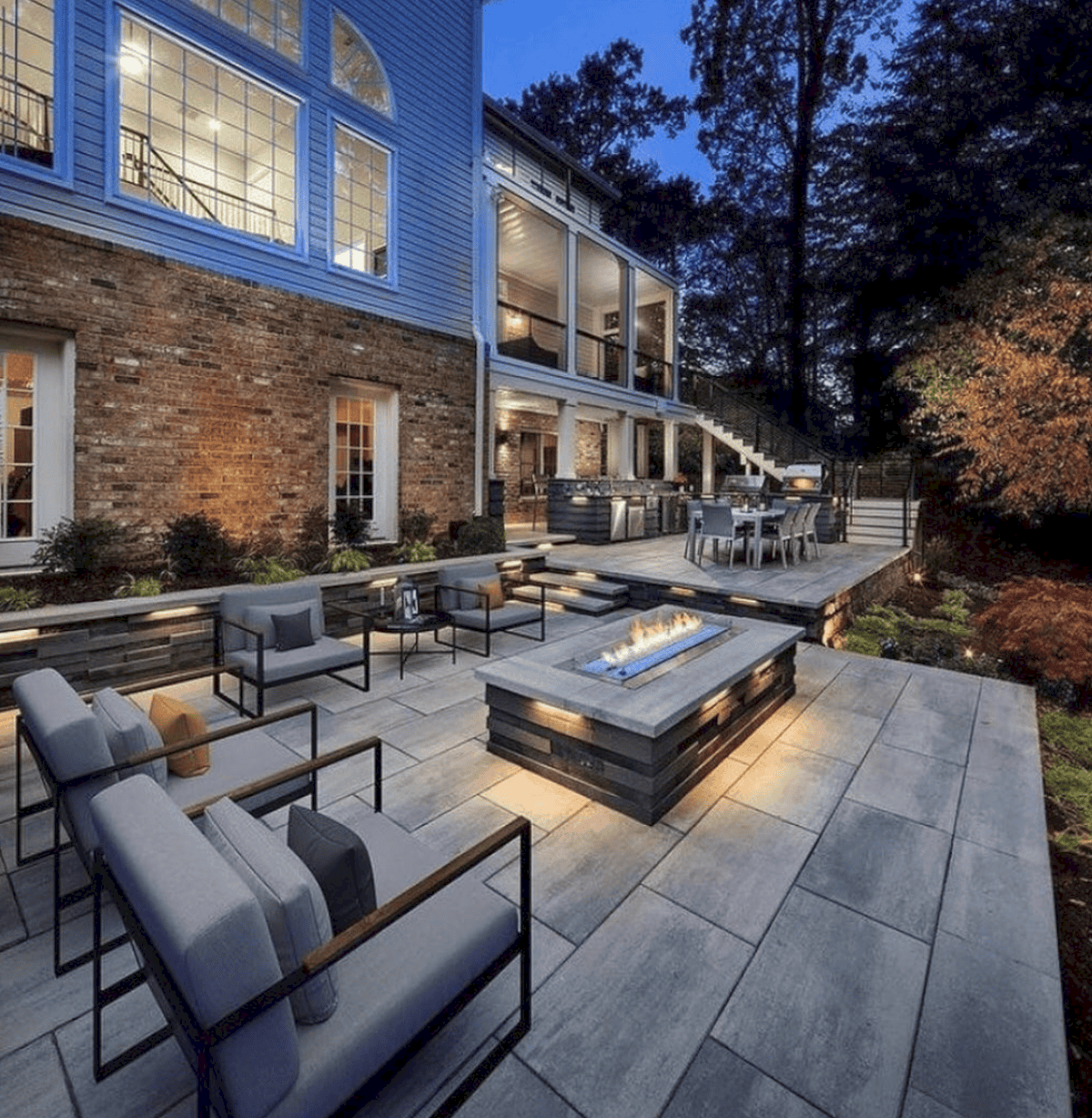 Outdoor living project showcasing stunning paver patio installation with modern fire pit, outdoor kitchen, retaining wall and landscape lighting | Expert Ward-Winning Landscape Design/Build in Bellevue | Home Service Specialists